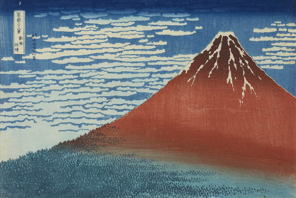 A print by Hokusai of Mount Fuji, showing the mountain as a red shape in front of a blue sky with ribbon clouds. Katsushika Hokusai, Clear Day with a Southern Breeze (Red Fuji), from the series Thirty-six Views of Mt. Fuji, c. 1830.