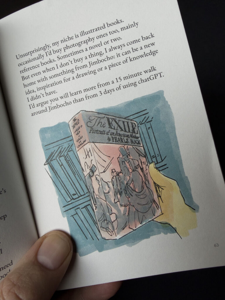 A spread from a story in the book about visiting a book festival, with an illustration of a hand holding a book. Part of the text above the illustration says “I’d argue you will learn more from a 15 minute walk around Jimbocho than from 3 days of using chatGPT.”