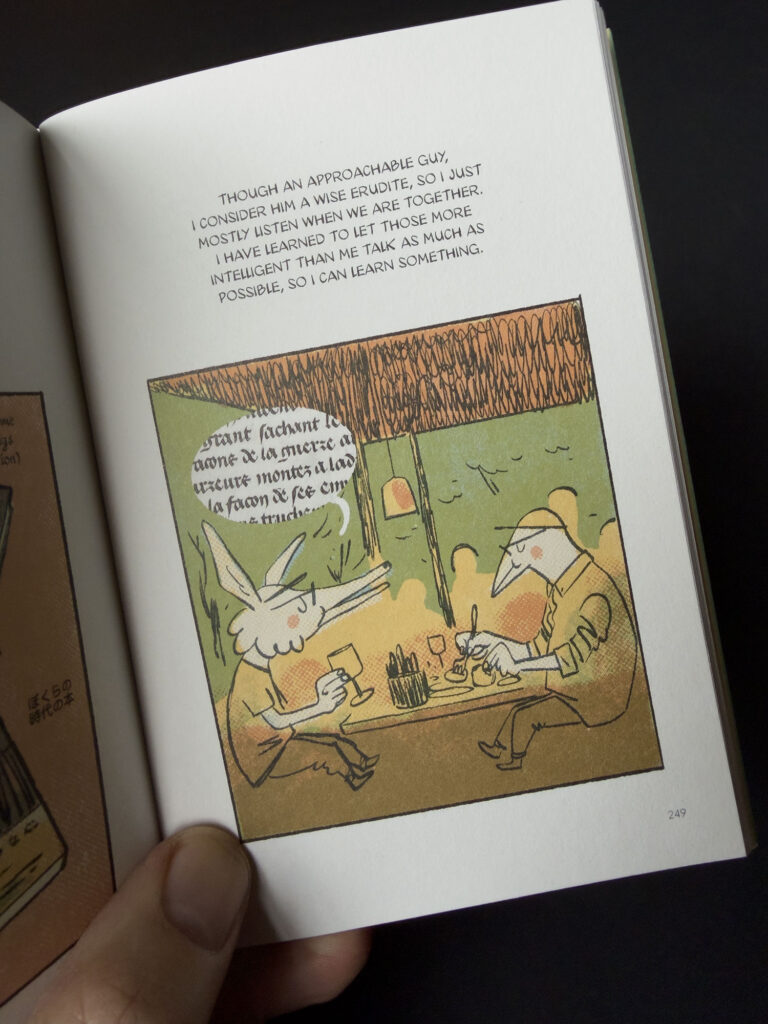 A page from the book showing an illustration of the author at dinner with author Craig Mod.